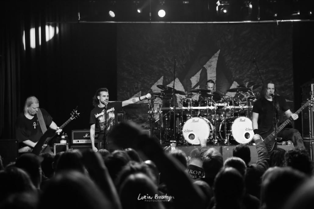 Black and white back-of-venue shot of the band Nile with 1 guest vocalist from their 2024 gig at Entrepot, Bruges, BE